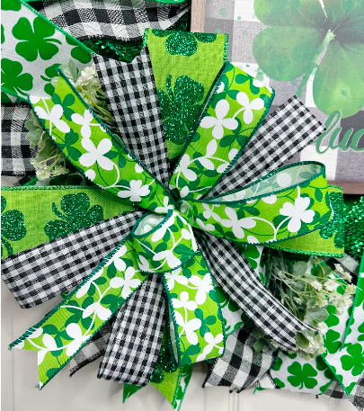Bow make with buffalo print ribbon, glittery shamrock ribbon and green and white clover ribbon